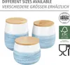 Three ceramic storage jars with wooden lids, displayed in varying sizes. The jars have a white upper half and a blue, textured lower half. Logos and text indicating product features and certifications are present on the right side. Produktbild-Vorschau