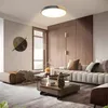 A modern living room with a sectional sofa, coffee table, and a decorative wall art. Voir les images du produit