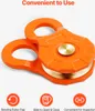 An orange pulley block with brass accents is shown against a white background, with feature icons and text below. Náhľad obrázku produktu