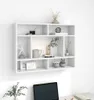 A white wall-mounted shelving unit with various decorative items on its shelves. Voir les images du produit