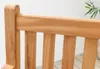 Close-up view of the wooden slats and top rail of an outdoor bench. Produktbild-Vorschau