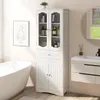 A white bathroom cabinet is shown in a bathroom setting next to a bathtub and sink. Podgląd zdjęcia produktu