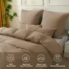 A bed with a duvet and pillows, styled in a bedroom setting. Produktbild-Vorschau