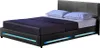 A black upholstered bed frame with blue LED lighting and two pillows on a white background. Produktbild-Vorschau