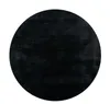 A black circular rug on a white background. Produktbild-Vorschau