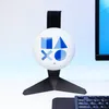 A white circular headset stand with PlayStation symbols on it, placed on a desk next to a computer monitor and keyboard. Anteprima dell’immagine prodotto