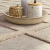 A close-up view of decorative items placed on a rug. Anteprima dell’immagine prodotto