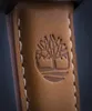 A close-up shot of a brown leather strap with the Timberland logo embossed on it. Náhled obrázku produktu