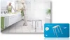 An elderly woman is using a shower stool in a bathroom, with a separate marketing image of the stool. Produktbild-Vorschau