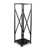 A black metal firewood rack with criss-cross supports and a square base, shown against a white background. Produktbild-Vorschau