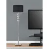A floor lamp with a black shade and a silver base with decorative spheres stands next to a television on a stand. Produktbild-Vorschau