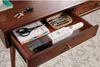 A hand vacuum cleaner is stored in a desk drawer along with other office supplies. Produktbild-Vorschau
