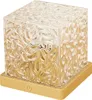 A cube-shaped lamp with a textured glass exterior and a gold base. Produktbild-Vorschau