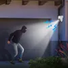 A burglar is illuminated by a security camera's light beam, with blue lightning graphics indicating an alert. Anteprima dell’immagine prodotto