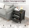 A black nightstand with three drawers is shown next to a gray sofa. The top drawer is slightly open, revealing items inside. The nightstand has a lamp and books on top. Below the nightstand are icons representing chargers, remote controls, glasses, and med Anteprima dell’immagine prodotto