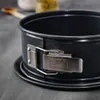A close-up of a dark gray springform pan with a silver latch and branding. Produktbild-Vorschau
