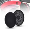 A pair of black headphone ear pads are shown in the foreground, with a red and black headphone visible in the background. Produktbild-Vorschau