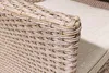 A close-up view of the corner of a woven outdoor bench with a beige cushion. Produktbild-Vorschau