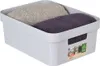 A light gray storage box containing two folded towels, one beige and one purple. Podgląd zdjęcia produktu