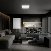 A modern living room and kitchen area with a large sectional sofa, coffee table, and dining set. Produktbild-Vorschau