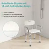 A shower chair in a shower stall with water falling from the showerhead. Produktbild-Vorschau