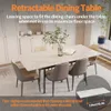 A dining table with chairs in a well-lit room with cabinets in the background. Produktbild-Vorschau