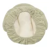 A top-down view of a light green, corduroy-covered cat bed with a cream-colored, textured interior. Náhled obrázku produktu