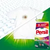 A split image showing a stained white t-shirt on the left and a clean white t-shirt with a Persil detergent package on the right, with green abstract light effects. Náhled obrázku produktu