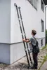 A man is holding a ladder against the side of a building. Náhľad obrázku produktu