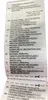 A close-up of a clothing care label with text in multiple languages. Voir les images du produit