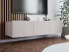 A modern TV stand with a fluted front is mounted on a slatted wooden wall above a herringbone wooden floor. Produktbild-Vorschau