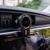 A car phone holder is mounted on the air vent of a car dashboard. Náhled obrázku produktu