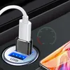 A close-up of a USB car charger with a phone charging cable plugged in, and a smartphone partially visible. Produktbild-Vorschau