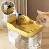 A cat drinking from a yellow pet water fountain. Produktbild-Vorschau
