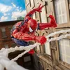 Spider-Man figure swinging between buildings with webs. Podgląd zdjęcia produktu