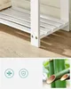 Close-up view of a white wooden shoe rack with a shoe on the top shelf, alongside icons and an image of bamboo. Náhled obrázku produktu