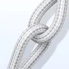 A close-up of a white braided USB cable tied in a knot. Produktbild-Vorschau