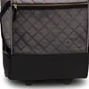 A close-up view of the bottom section of a gray quilted bag with a black mesh pocket and a black base. Voir les images du produit