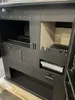 Interior view of a black wood-burning stove with two compartments and grates. Produktbild-Vorschau