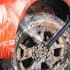 A car wheel and fender being cleaned with a pressure washer. Náhľad obrázku produktu
