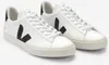A pair of white VEJA sneakers with black accents. Produktbild-Vorschau