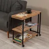 A side table next to a sofa, with books, glasses, and a cup of coffee on it. Voir les images du produit