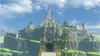 A grand castle situated on a rocky cliff overlooking a green landscape under a blue sky with clouds. Náhled obrázku produktu