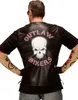 A person wearing a black t-shirt and a black leather vest with a skull design. Produktbild-Vorschau