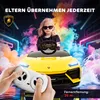 A young girl in sunglasses sits in a yellow toy Lamborghini, holding a remote control. The background is dark with colorful smoke and neon lights. Produktbild-Vorschau