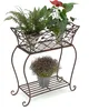 A three-tiered metal plant stand with three potted plants. Anteprima dell’immagine prodotto