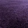 A close-up, angled view of a shaggy purple rug. Anteprima dell’immagine prodotto