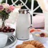 A picnic setting with a thermos, fruit, and pastries. Anteprima dell’immagine prodotto