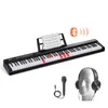 A digital piano with accessories, including a microphone and headphones, set against a white background. Náhled obrázku produktu
