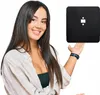 A woman is presenting a black square object. Anteprima dell’immagine prodotto